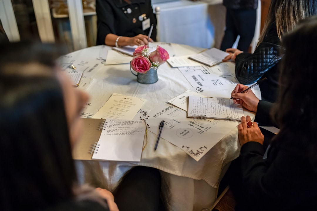 Day-of Coordination: What It Covers and Why It Matters 2 Wedding vendors setting up floral arrangements under coordinator guidance