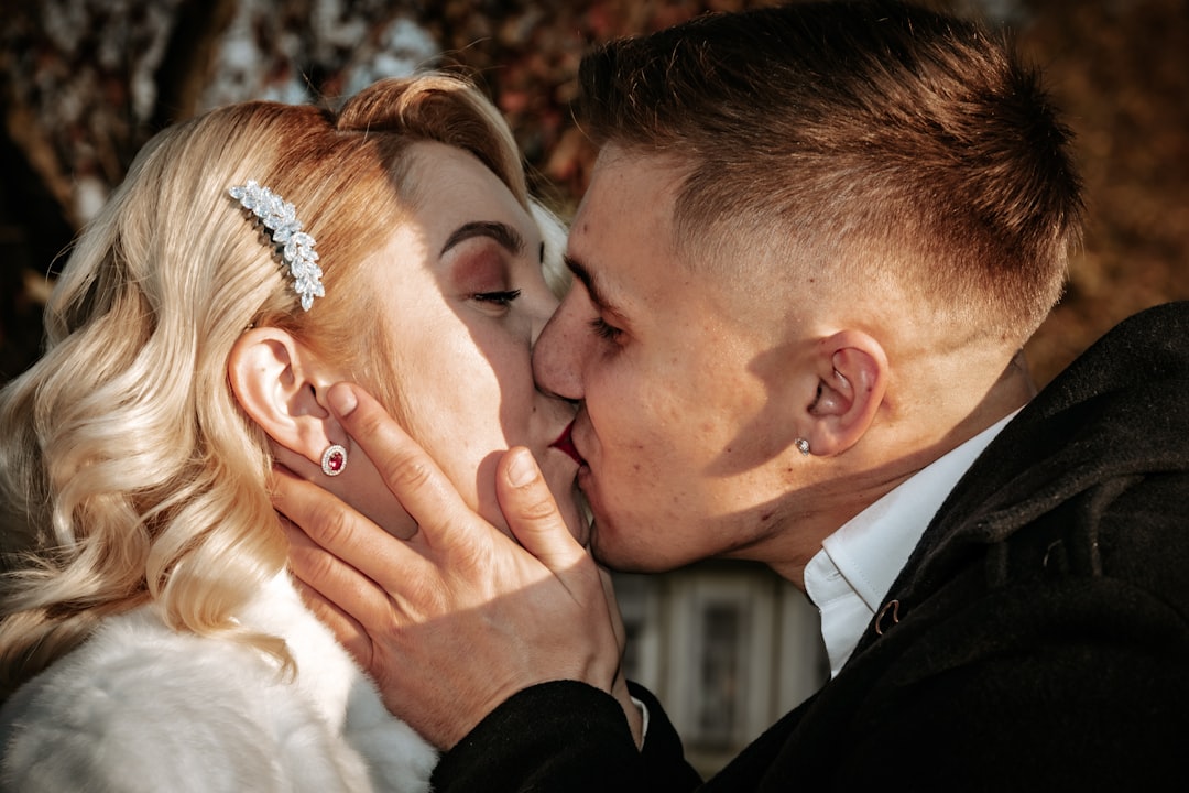 Wedding photographer capturing intimate couple portrait in natural light