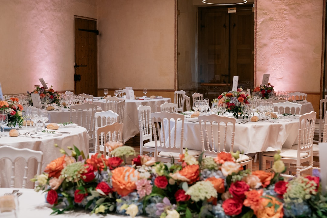 Elegant wedding reception table setup with floral centerpieces and candlelight