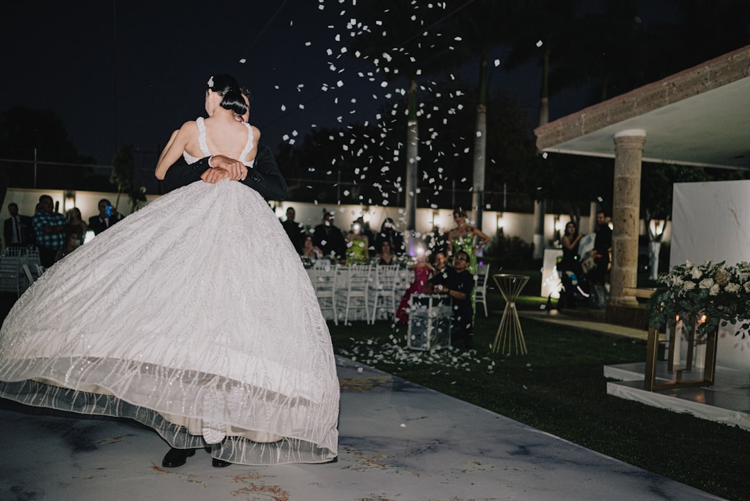Wedding couple sharing their first dance under elegant lighting